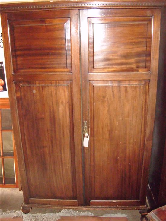 Mahogany wardrobe enclosed by a pair of panelled doors